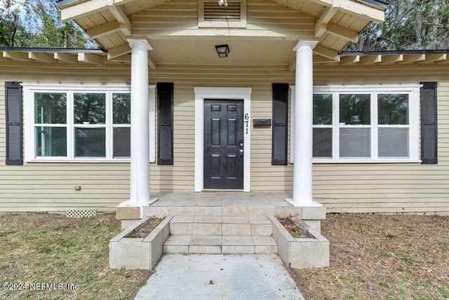 doorway to property featuring a porch