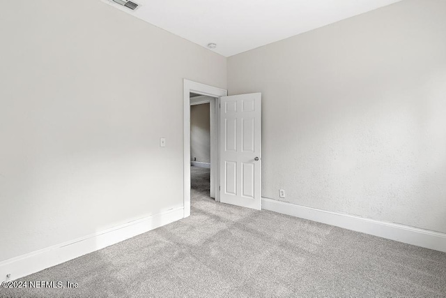 spare room with light colored carpet