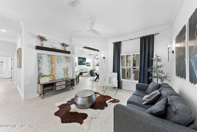 living room with light tile patterned floors, ceiling fan, and ornamental molding