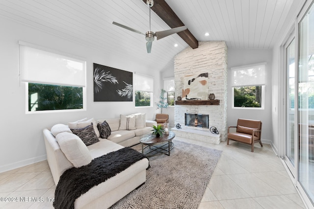 tiled living room with lofted ceiling with beams, a stone fireplace, ceiling fan, and wooden ceiling