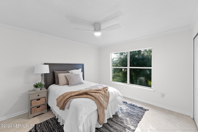 bedroom featuring ceiling fan, crown molding, and light tile patterned flooring