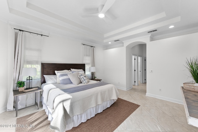 bedroom with a raised ceiling, ceiling fan, crown molding, and light tile patterned flooring