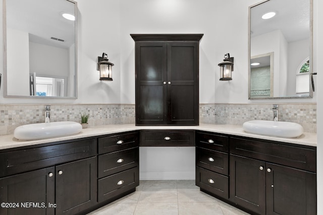 bathroom featuring vanity, backsplash, and tile patterned floors