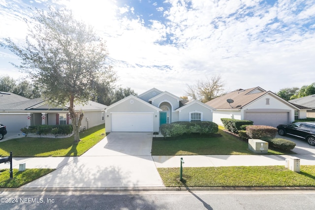 ranch-style home with a garage and a front yard