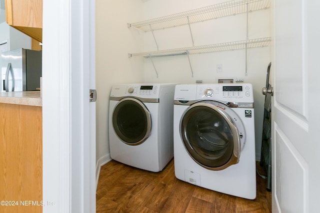 laundry room featuring independent washer and dryer and dark wood-type flooring