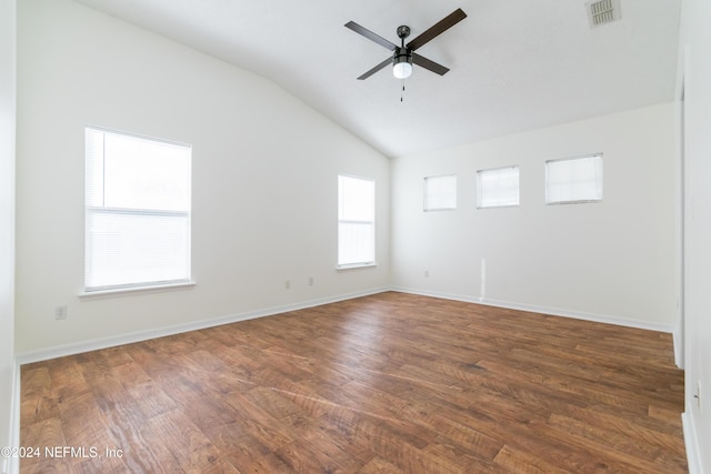 spare room with ceiling fan, plenty of natural light, dark hardwood / wood-style floors, and vaulted ceiling