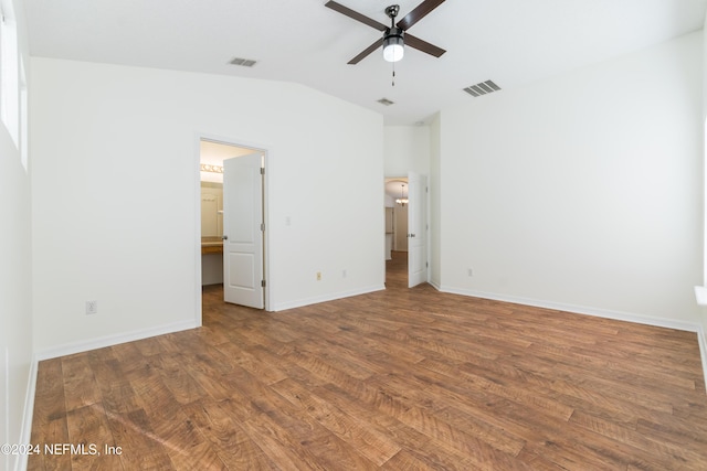 unfurnished bedroom with hardwood / wood-style flooring, ceiling fan, lofted ceiling, and connected bathroom