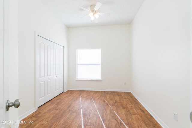 unfurnished bedroom featuring a closet, ceiling fan, and hardwood / wood-style floors