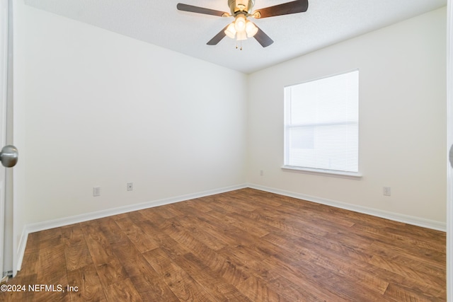 spare room featuring ceiling fan and dark hardwood / wood-style floors