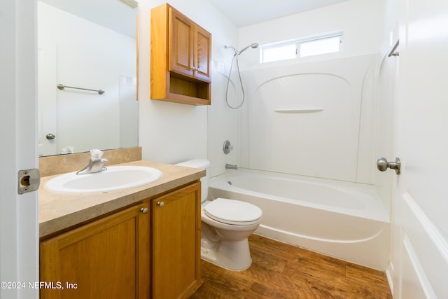 full bathroom featuring hardwood / wood-style floors, vanity, toilet, and tub / shower combination