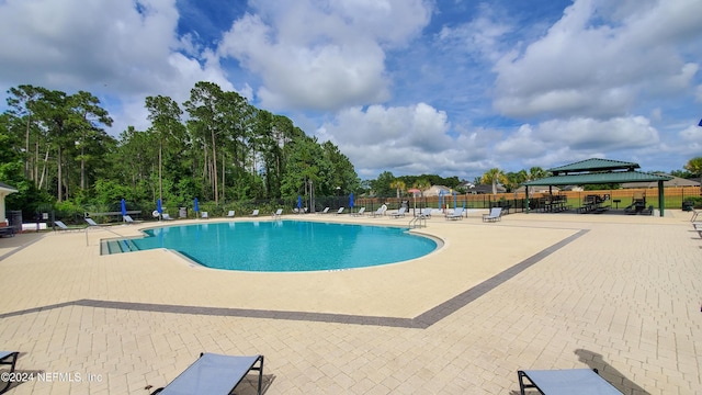 view of swimming pool featuring a gazebo and a patio