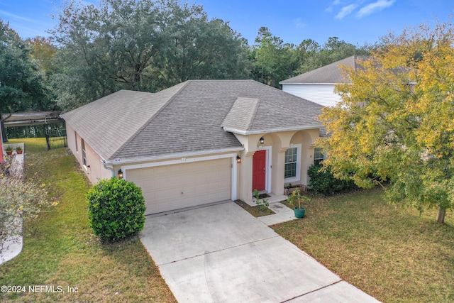 view of front facade with a front yard and a garage