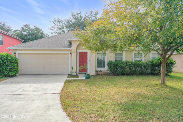 obstructed view of property featuring a garage and a front yard