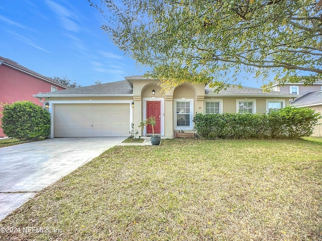 view of front of property featuring a garage and a front lawn