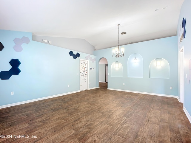 empty room with lofted ceiling, dark wood-type flooring, and a notable chandelier