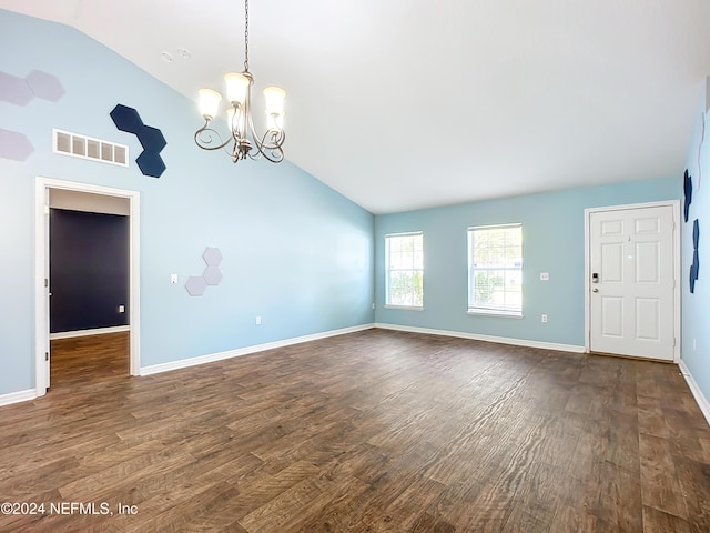 unfurnished room featuring a chandelier, vaulted ceiling, and dark wood-type flooring