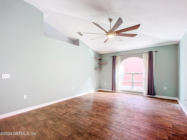 empty room featuring wood-type flooring, a textured ceiling, vaulted ceiling, and ceiling fan