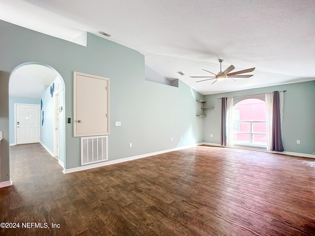 empty room with hardwood / wood-style flooring, ceiling fan, and vaulted ceiling