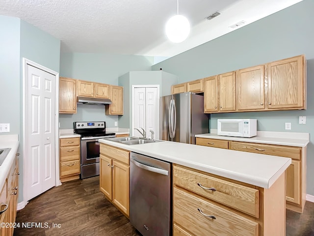 kitchen with light brown cabinets, an island with sink, appliances with stainless steel finishes, and dark wood-type flooring