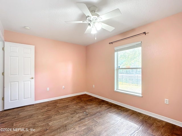 empty room with ceiling fan and dark wood-type flooring