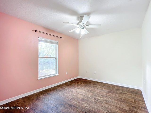 empty room with a textured ceiling, ceiling fan, and dark wood-type flooring