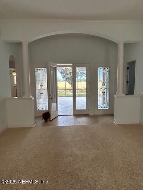 unfurnished room with light carpet and french doors