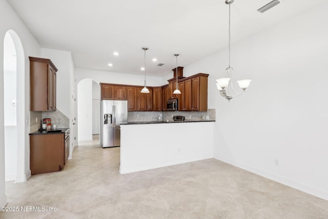 kitchen with decorative backsplash, appliances with stainless steel finishes, light tile patterned floors, decorative light fixtures, and an inviting chandelier