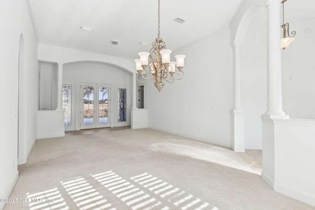 interior space with decorative columns, an inviting chandelier, and ornamental molding