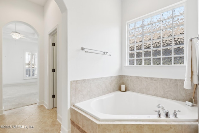 bathroom featuring tile patterned flooring and tiled tub