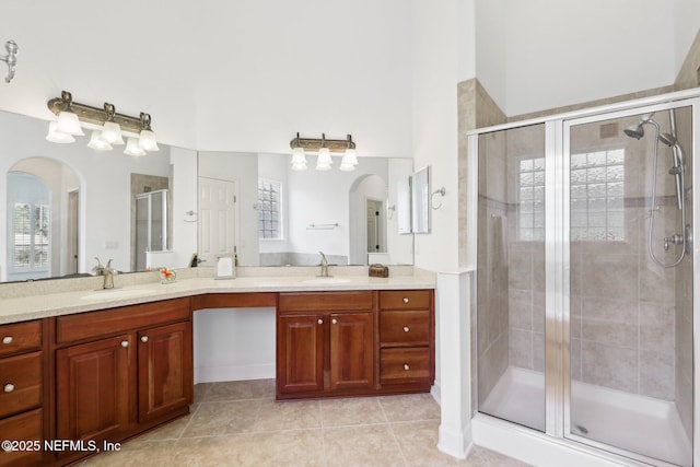 bathroom featuring tile patterned flooring, vanity, and walk in shower