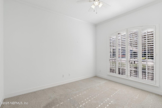 spare room with ceiling fan and crown molding