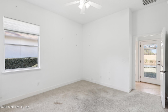 carpeted empty room featuring ceiling fan