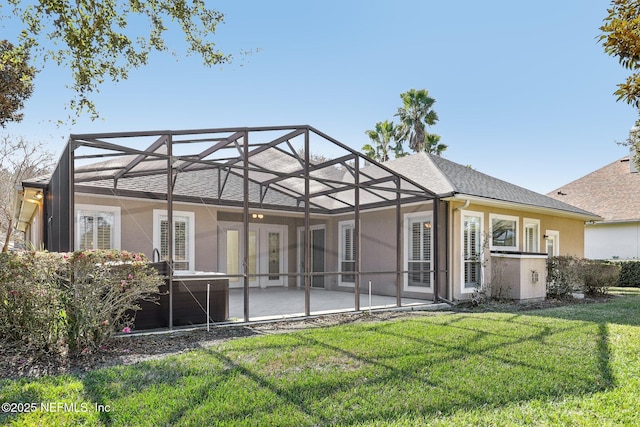 back of house with a lanai, a yard, and a patio