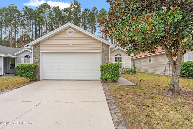 ranch-style home with a front yard and a garage