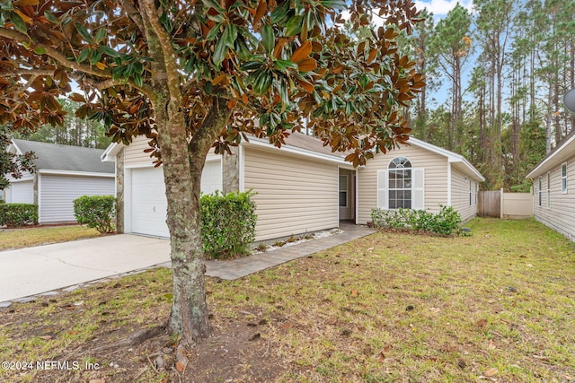 view of front facade with a garage and a front lawn