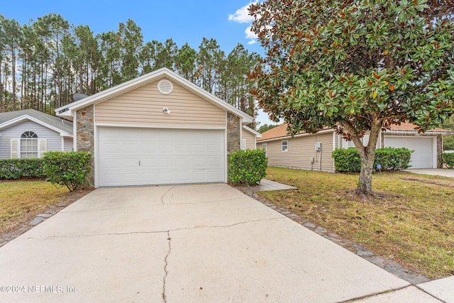 view of front of property featuring a garage and a front lawn