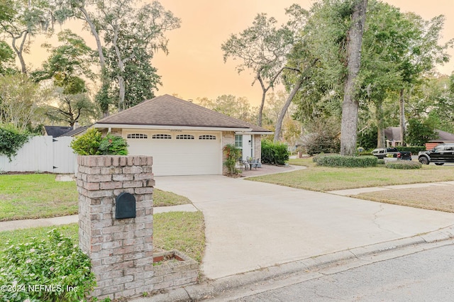 view of front of home featuring a yard and a garage