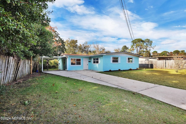 ranch-style house with a carport and a front lawn