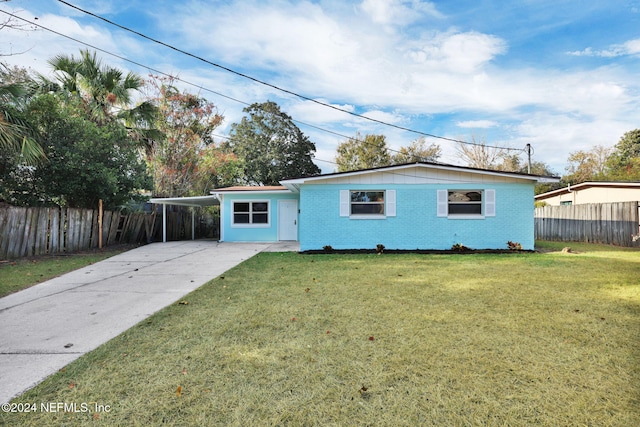 single story home with a front yard and a carport