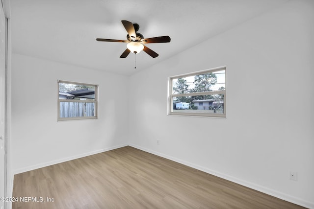 unfurnished room featuring ceiling fan, lofted ceiling, and light hardwood / wood-style flooring