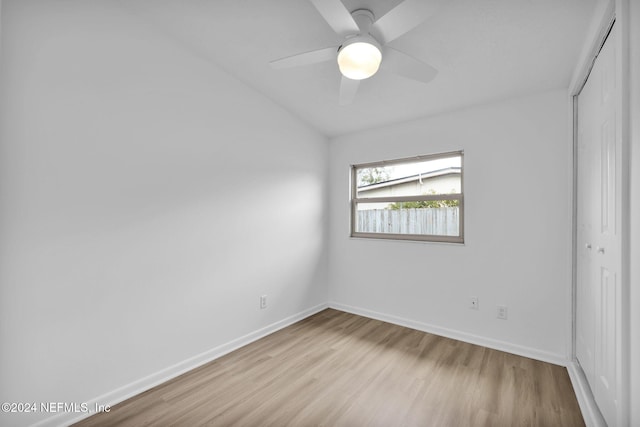 unfurnished bedroom featuring ceiling fan, light hardwood / wood-style floors, and a closet