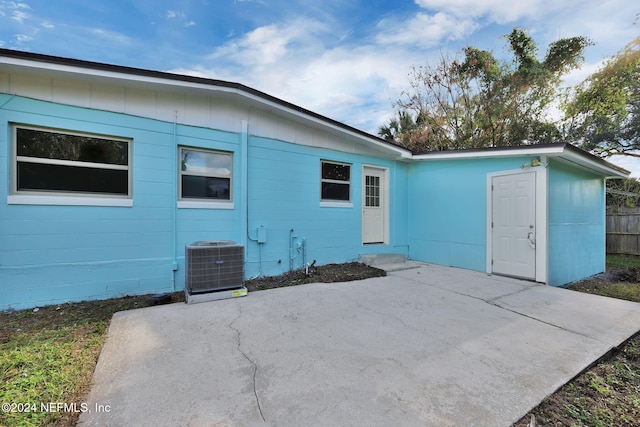 rear view of house with a patio area and central AC unit