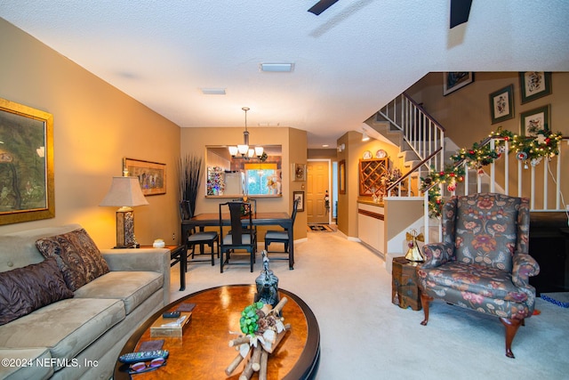 living room featuring a textured ceiling, light carpet, and a chandelier