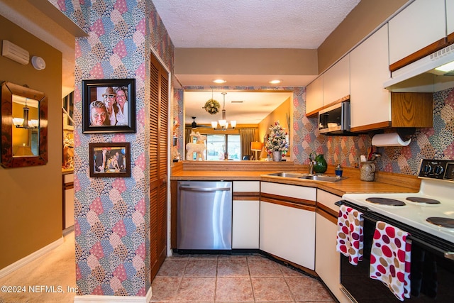 kitchen featuring pendant lighting, white cabinets, electric stove, sink, and stainless steel dishwasher