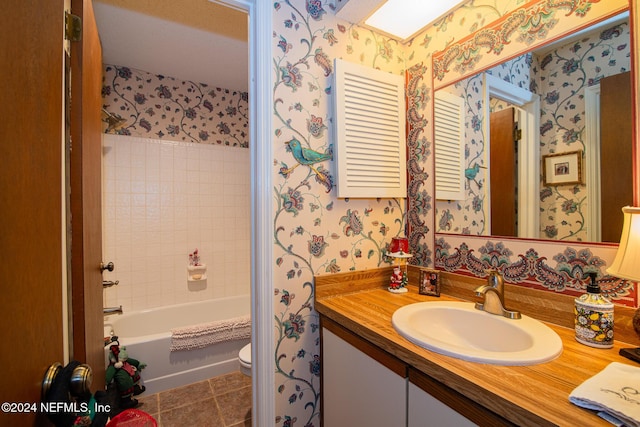 full bathroom with tile patterned flooring, vanity, tub / shower combination, and toilet