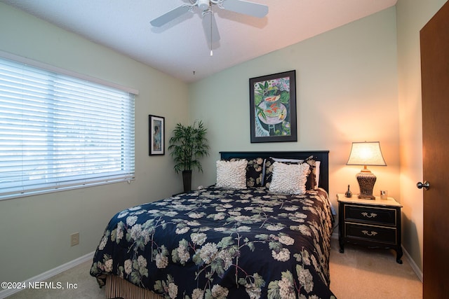 carpeted bedroom with ceiling fan and lofted ceiling