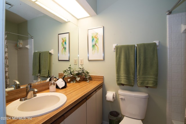 bathroom featuring a shower, vanity, and toilet