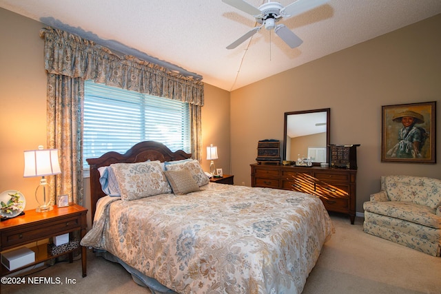 bedroom with light carpet, a textured ceiling, ceiling fan, and lofted ceiling