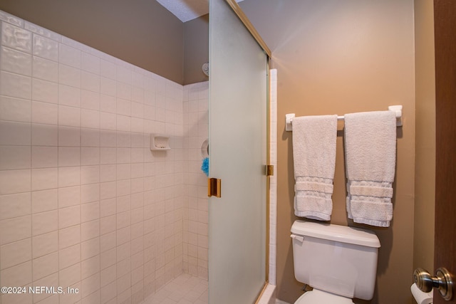 bathroom with toilet and an enclosed shower