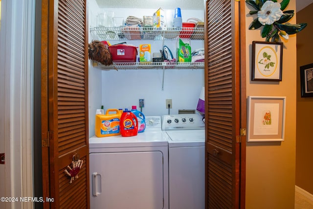 washroom featuring washer and dryer and a textured ceiling